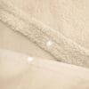 Beige fleece stof met drukknopen detail